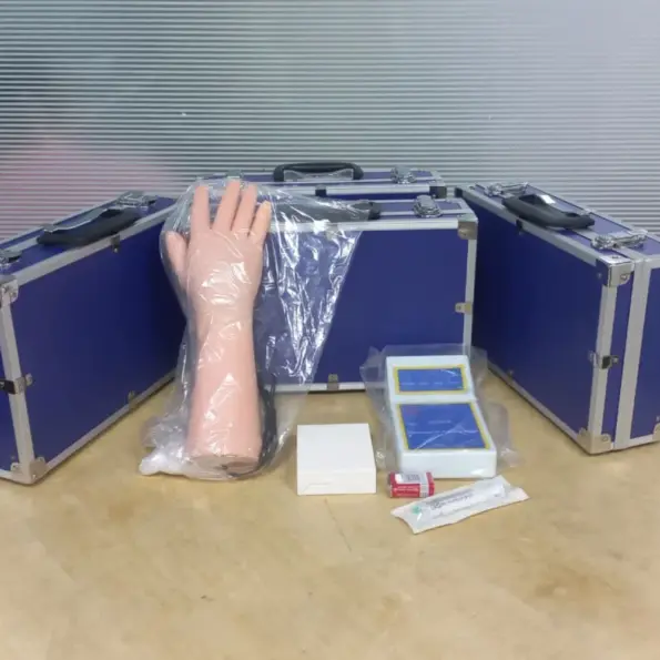 Complete electronic IV training hand set with lifelike arm model, control unit, accessories, and carry cases for nursing venipuncture practice.