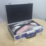 IV training arm model secured inside protective carry case with foam lining for safe storage and transport.