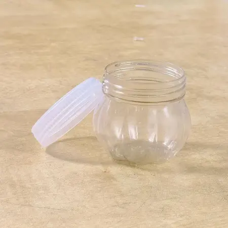 mini transparent plastic jar with white lid front view