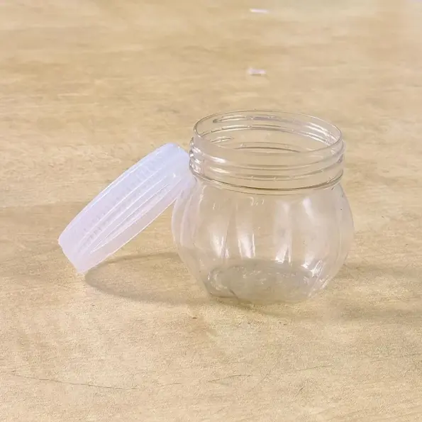 mini transparent plastic jar with white lid front view