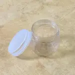 mini transparent plastic jar with white lid front view