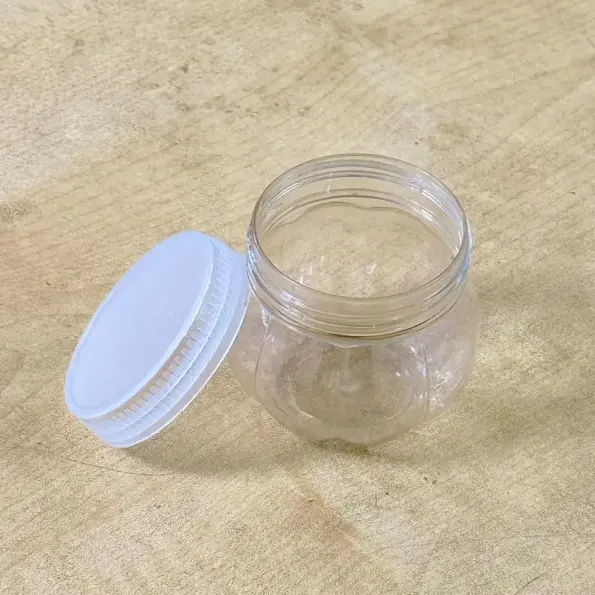 mini transparent plastic jar with white lid front view