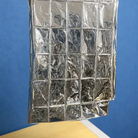 Reflective aluminum foil insulation blanket measurement with measuring tape